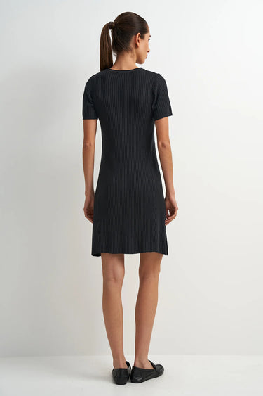 Woman wearing a black dress on a white background