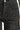 A close up on embellished black jeans on a white background