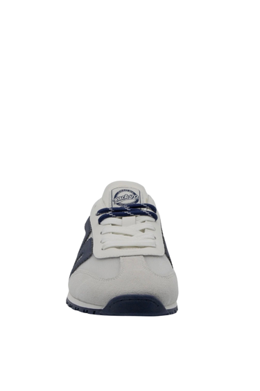 White sneaker with navy accents on a white background