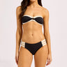 Black and white multi strap bikini bottom with banded top on a plain background