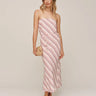 Woman wearing a strapless pink and white striped dress on a plain background