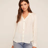A woman wearing a relaxed blouse with a shadow satin gingham for a subtle sheen and elevated texture on a white background.