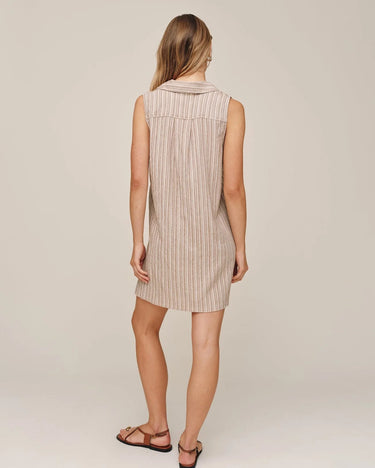 Woman wearing a striped dress on a plain background