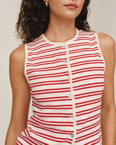 Red and white striped sleeveless top worn by a person on a plain background