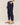 Navy blue pants worn by a person on a beige background