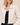 A close up on a white faux leather bomber jacket