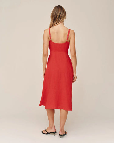 Red dress worn by a person on a beige background