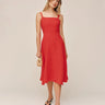Woman wearing a red dress against a plain background