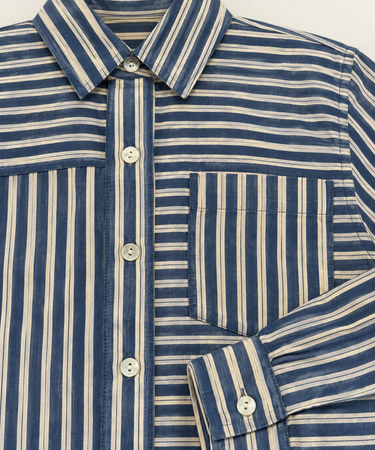 Close-up of Bella Dahl Seamed Button Down Shirt in Vintage Navy showing mixed navy stripes, front pocket and button details