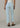 Light blue jeans worn by a person on a neutral background