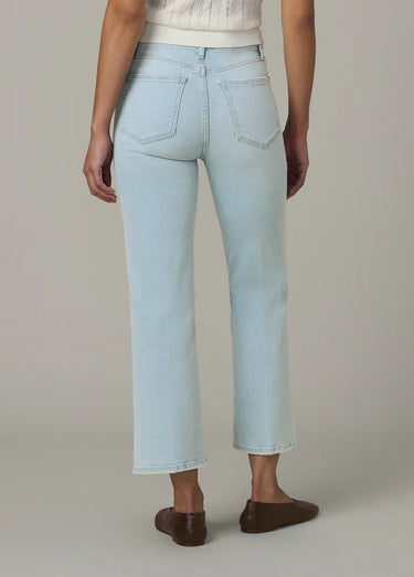 Light blue jeans worn by a person on a neutral background