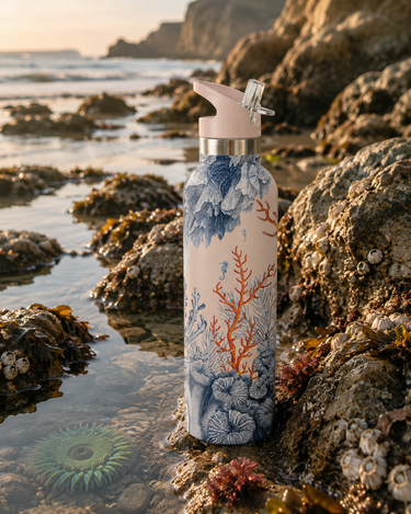 Water bottle with ocean design on a rocky beach