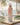 Tropical patterned water bottle on a wooden surface with blurred beach background