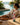 Woman relaxing by a pool with a colorful water bottle on a table