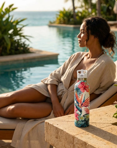 Woman relaxing by a pool with a colorful water bottle on a table