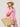 Woman in pink shirt and straw hat holding a straw bag with beach-themed decorations on a white background