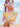 Person holding a straw bag with beach-themed decorations against a beach background