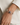A woman wearing a horsebit bracelet with a peacock pearl stone in the center