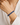 A close-up of a person's wrist wearing a dark blue beaded spiral bracelet