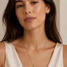 A woman wearing a sterling silver necklace with a Smokey quartz pendant.