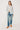 Woman wearing a striped shirt and jeans on a white background