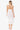 Woman wearing a white crochet dress on a white background