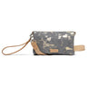 A canvas wristlet clutch bag with a gray and beige splatter pattern, featuring tan leather trim, a wrist strap, and a brand label reading 'CONSUELA'.