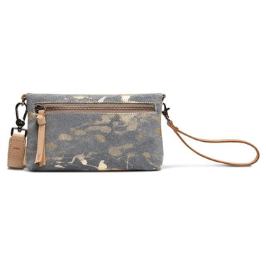 A canvas wristlet clutch bag with a gray and beige splatter pattern, featuring tan leather trim, and a wrist strap