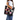 A person wearing a light blue shirt and blue jeans carries a consuela black quilted marisol tote bag decorated with colorful heart-shaped patches on a plain white background.