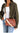 A woman wearing an olive green shirt and blue jeans carries a brown embossed leather crossbody bag with a beige strap and a colorful striped shoulder strap detail.
