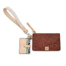 A brown embossed leather wristlet clutch with a matching beige patterned wrist strap and a small beige card holder tag, shown on a plain white background.