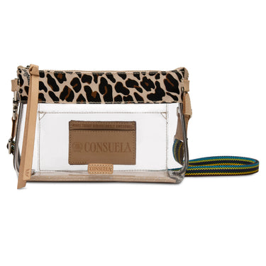 A clear plastic crossbody bag with a leopard print top flap, a tan faux-leather brand patch reading 'CONSUELA', and a green, blue, and yellow patterned strap, shown on a white background.