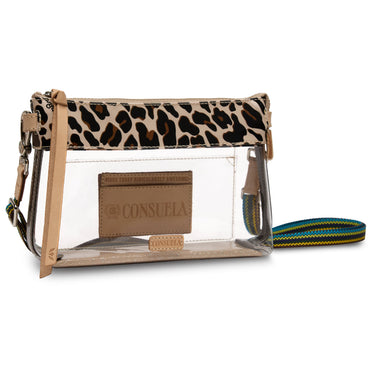 A clear plastic crossbody pouch bag with a leopard print top flap, tan leather trim, a front brand patch reading Consuela, and a multicolor striped woven strap on a white background.