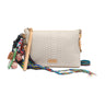 Beige textured handbag with colorful strap and decorative elements on a white background