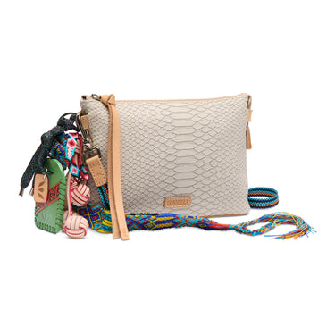 Beige textured handbag with colorful strap and accessories on a white background