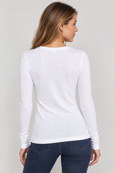 A woman shown from the back wearing a fitted white long-sleeve top and dark blue jeans against a light gray studio background.