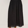 woman wearing black embroidery maxi skirt on white background