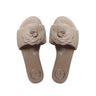 Pair of beige sandals with floral designs on a white background