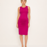 Woman wearing a bright pink sleeveless dress on a white background