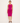 Woman wearing a bright pink sleeveless dress on a white background