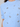a woman wearing a blue knit short sleeve sweater with sparkling floral embellishments on a neutral background