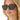 Close-up of a person wearing tortoiseshell sunglasses with a blurred background