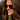 Woman wearing sunglasses with a blurred natural background