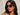 Woman wearing tortoiseshell sunglasses against a light background