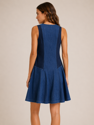 Woman wearing a blue dress against a beige background