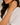 Close-up of a person wearing a silver bracelet on a neutral background