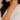 Close-up of a woman wearing a silver bracelet on a neutral background