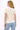 Woman wearing a white t-shirt and light blue jeans on a white background
