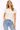 Woman wearing a white t-shirt and blue jeans on a white background