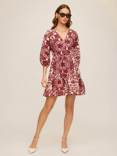Woman wearing a red floral dress on a white background